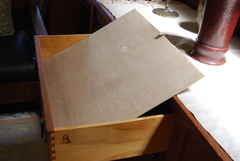 Detail, original fabric drawer inset and branded signature on side of drawer.